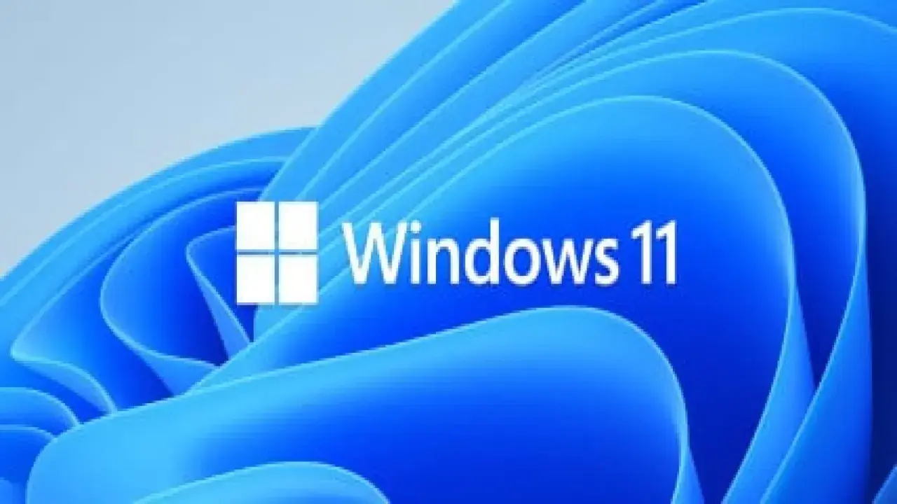 Logo de Windows 11 sobre fondo azul ondulado. Averigua cuanto cuesta instalar Windows 11 y renueva tu sistema.