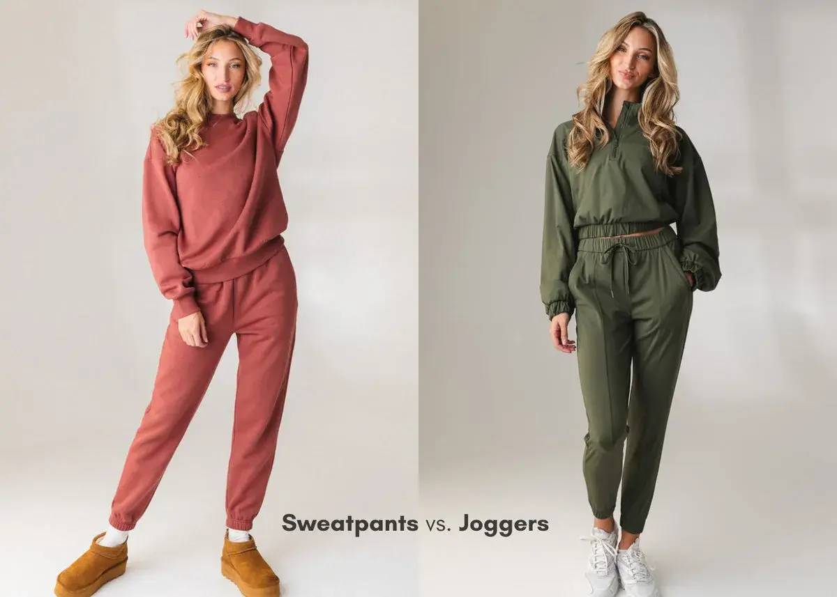 Two women model outfits. The woman on the left wears rust-colored sweatpants and a matching sweatshirt. The woman on the right wears olive green joggers and a matching cropped jacket.