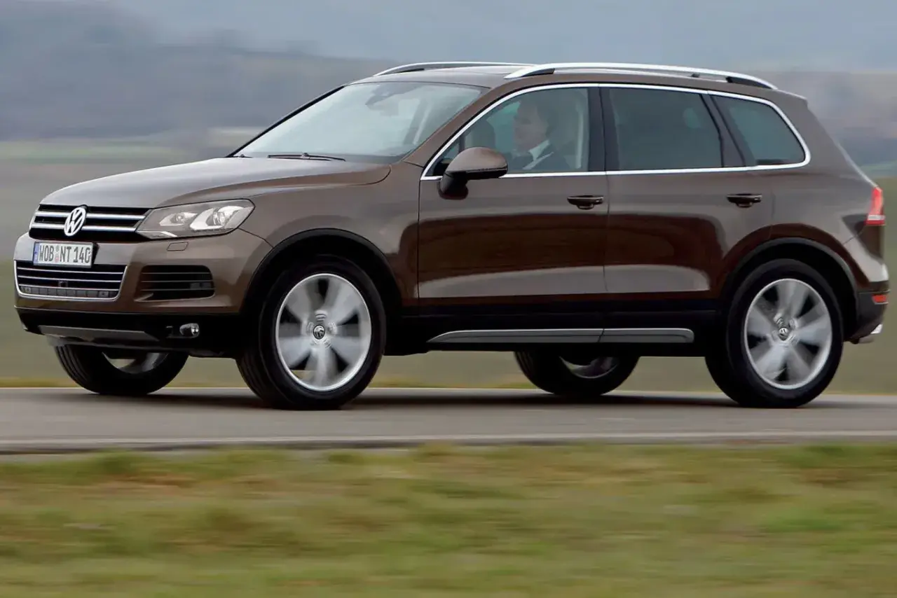 Brązowy Volkswagen Touareg w ruchu. Ten model to jeden z najmniej awaryjnych SUV-ów 10 letnich, idealny na długie podróże.