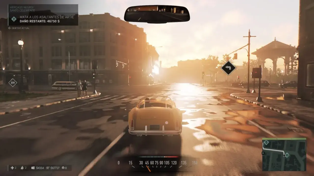 Conduciendo un coche clásico en una calle mojada, con el sol del atardecer iluminando la ciudad. El objetivo actual en Mafia 3 es eliminar a los asaltantes de Artie.