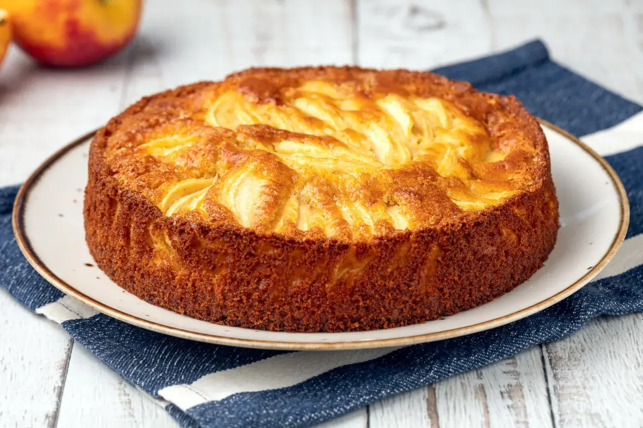 Torta semplice di mele, dorata e profumata, pronta per essere gustata.