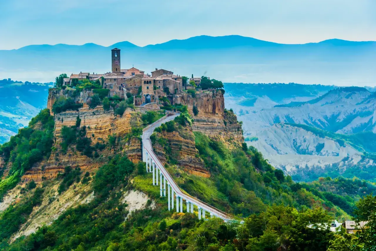 Civita di Bagnoregio, un borgo antico arroccato su una rupe, collegato da un ponte pedonale.