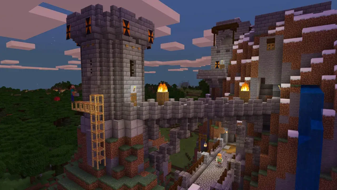 Kamienna twierdza w Minecraft, zbudowana na zboczu góry. Widać wieże, mosty, pochodnie i wodospad. Gra wymaga kreatywności!
