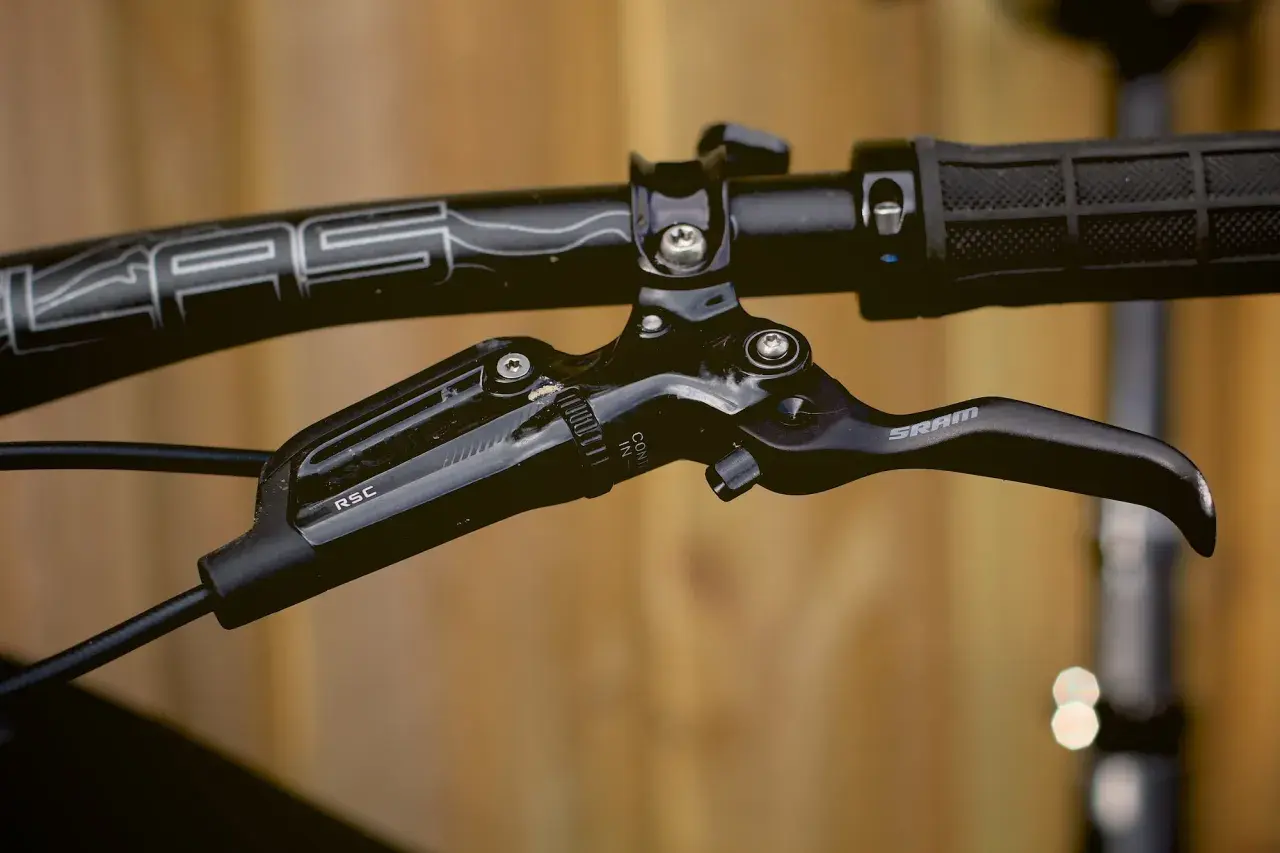 Close-up of a black SRAM Guide RSC brakes lever on a bicycle handlebar.