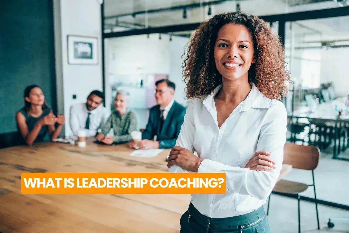 A confident woman leads a team meeting, embodying the essence of leadership coaching definition.