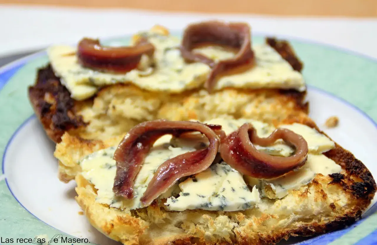 Tostada con queso azul y anchoas. Una combinación deliciosa que responde a la pregunta: ¿qué queso combina con anchoas?