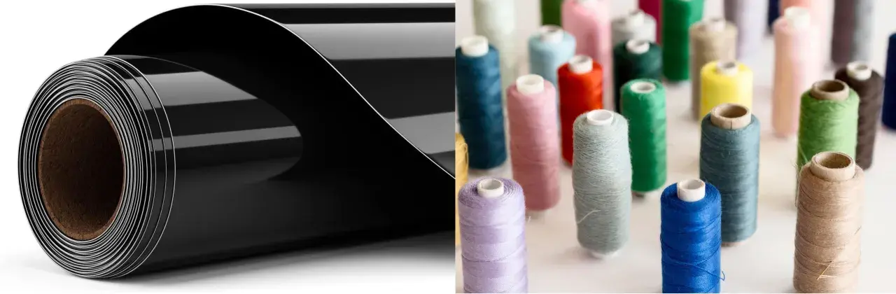 Rouleau de vinyle noir brillant pour flocage textile, à côté de bobines de fil colorées.