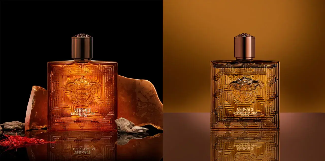 Złota butelka Versace Eros Parfum, otoczona kamieniami i szafranem, emanuje luksusem.