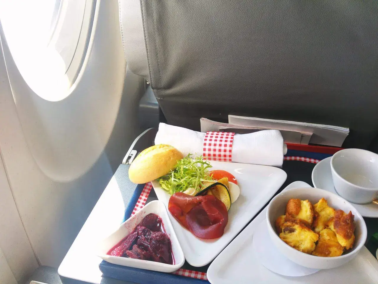 Smaczne posiłki flydubai: pieczone mięso, warzywa, sałatka, pieczywo i deser.