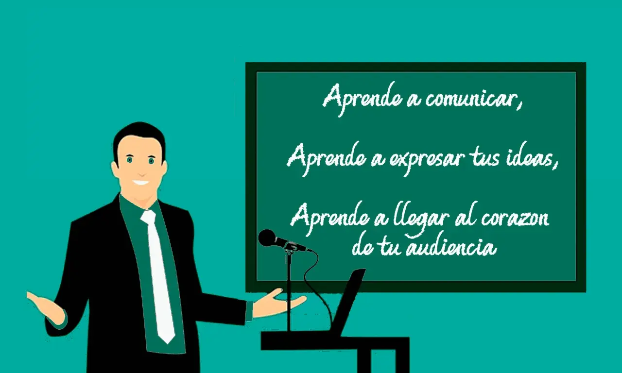 Un orador sonriente, con un traje negro y corbata blanca, presenta en una pizarra. La pizarra muestra un ejemplo de qué es una anáfora: "Aprende a comunicar, Aprende a expresar tus ideas, Aprende a llegar al corazón de tu audiencia".