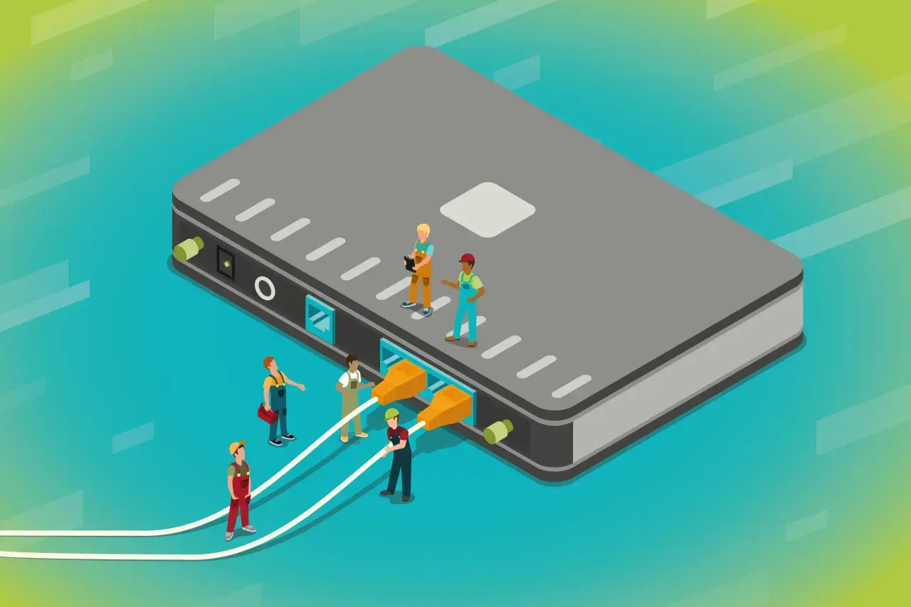 Des ouvriers connectent des câbles à un grand boîtier gris, illustrant a quoi sert un switch : relier plusieurs appareils pour un réseau.
