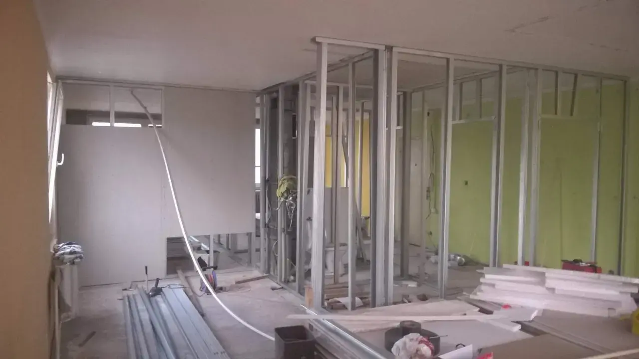 Costruzione di pareti in cartongesso, un materiale che, sebbene comune, è tossico e richiede attenzione durante la manipolazione.