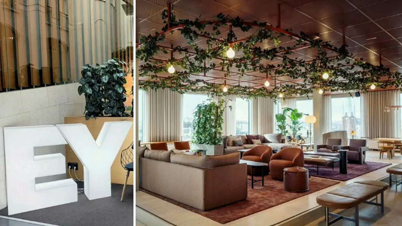 Stora vita bokstäver "EY" och en modern lounge med växter i taket, perfekt för att jobba hybrid.