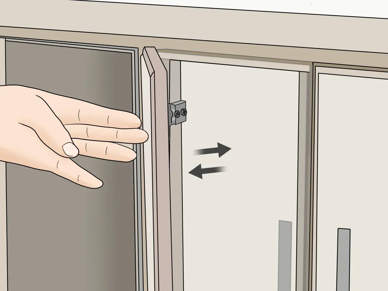 Mano ajustando la puerta de un armario con bisagras.