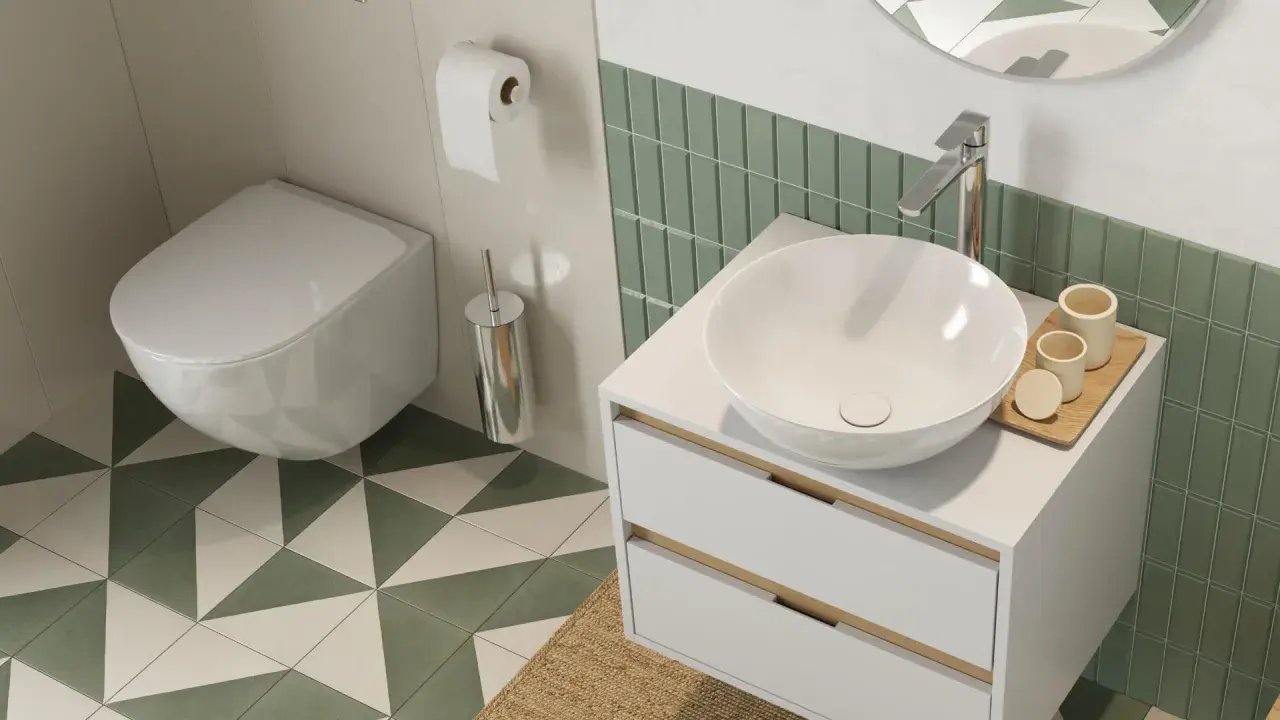 Nowoczesna łazienka z białym, wiszącym wc w rogu, umywalką nablatową i zielonymi płytkami.