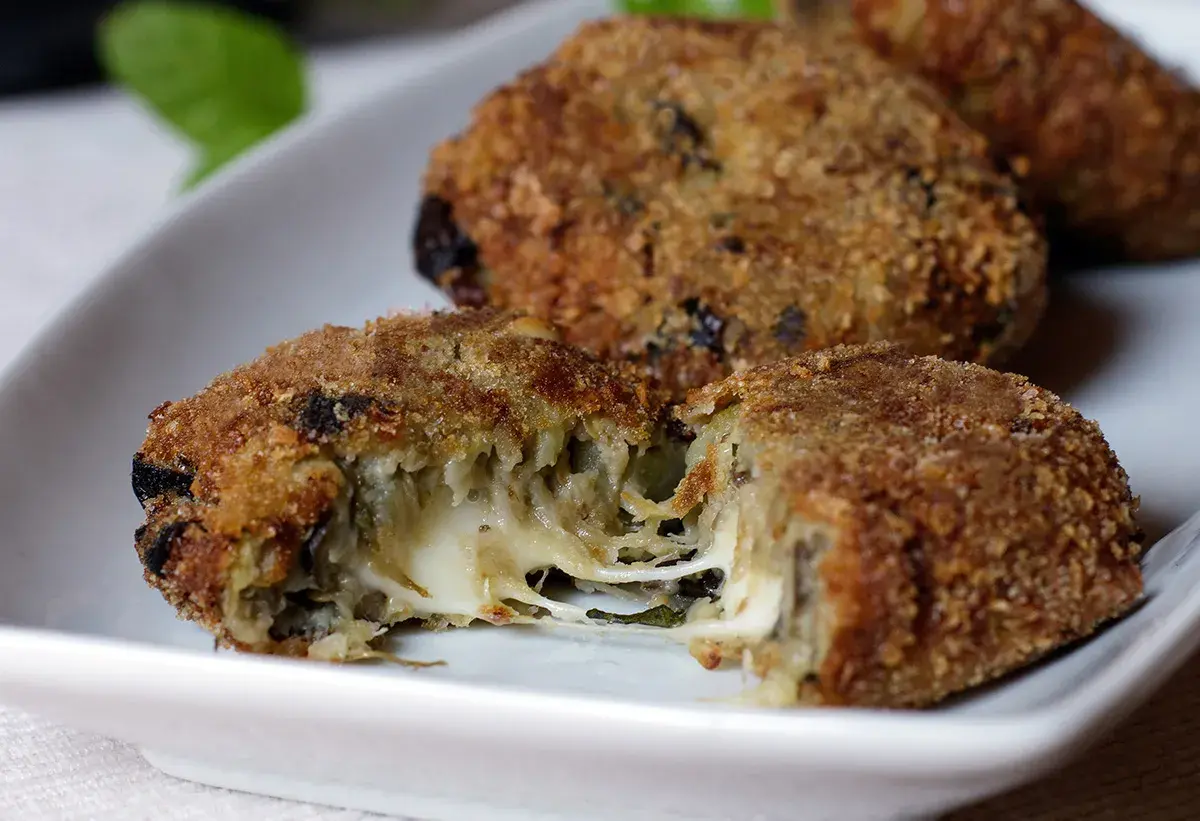 Polpette di melanzane calabresi dorate e croccanti, con un cuore filante di formaggio.