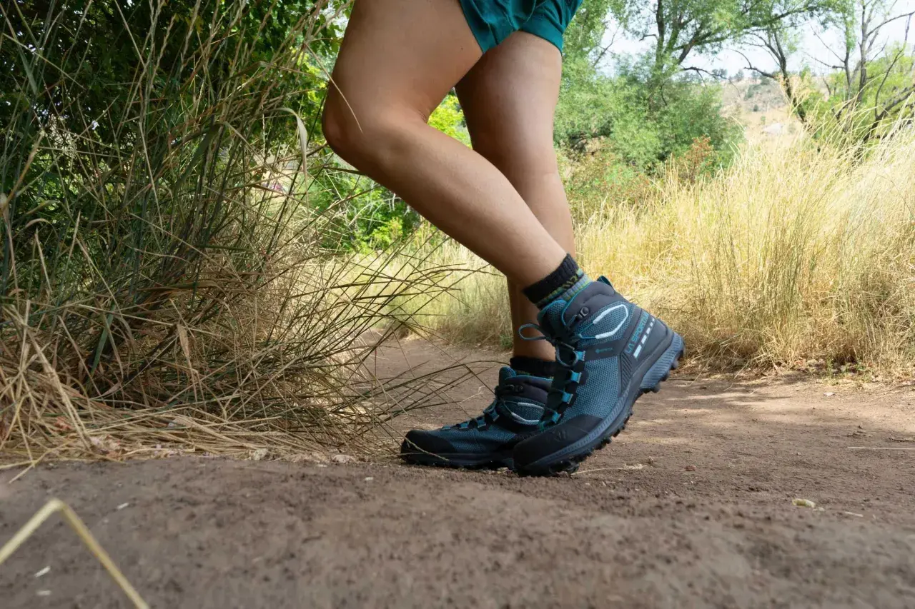 Hiking boots provide excellent ankle support and grip, crucial for navigating this dusty trail. Enjoy the benefits of secure footing on your next adventure.