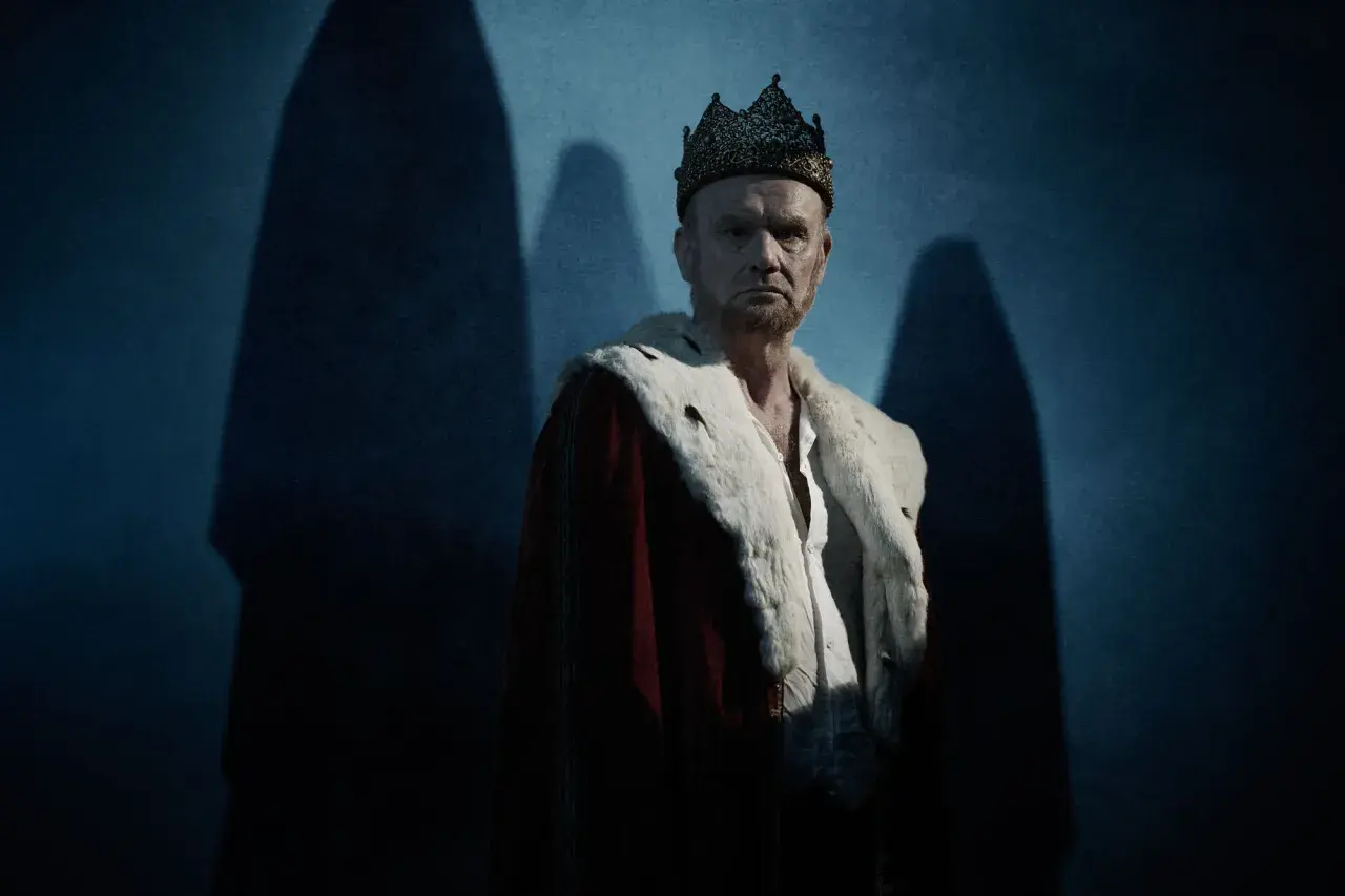 En dyster kung med krona och hermelinskrage. Bilden ger en känsla av makt och förfall, som i pjäsen om vad handlar Macbeth om.