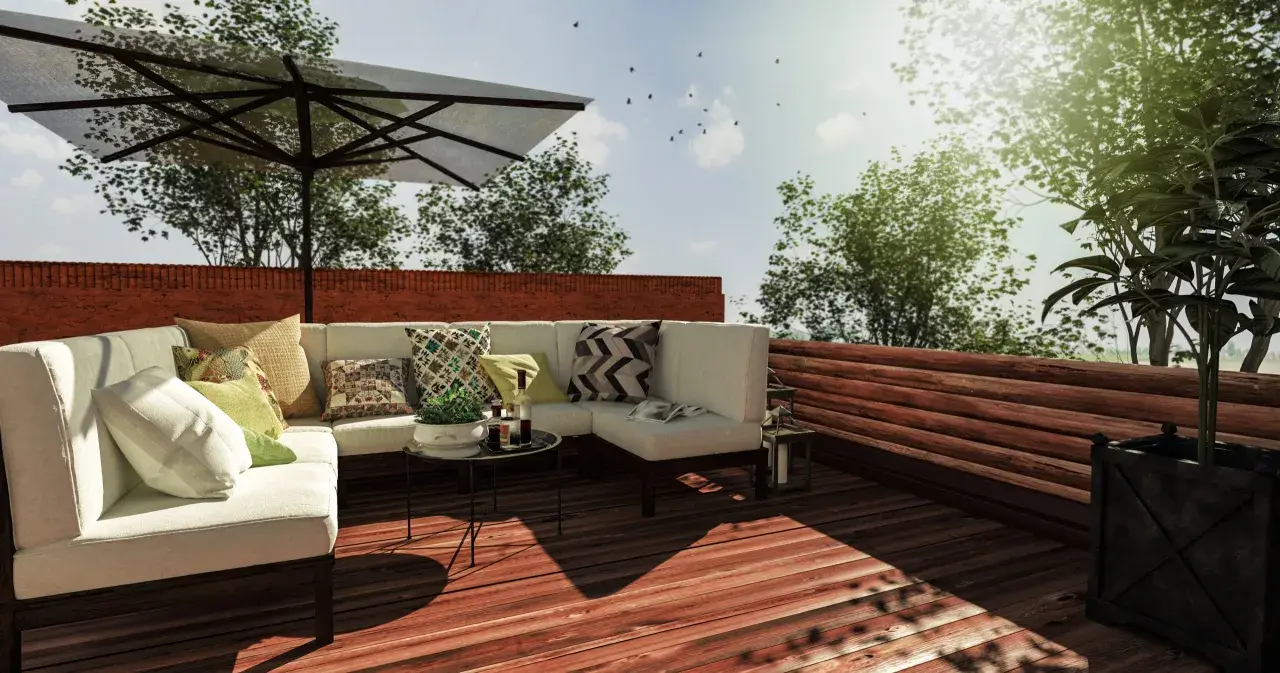 Aménagement toit terrasse avec canapé, parasol et vue sur la verdure. Un projet qui demande une autorisation.