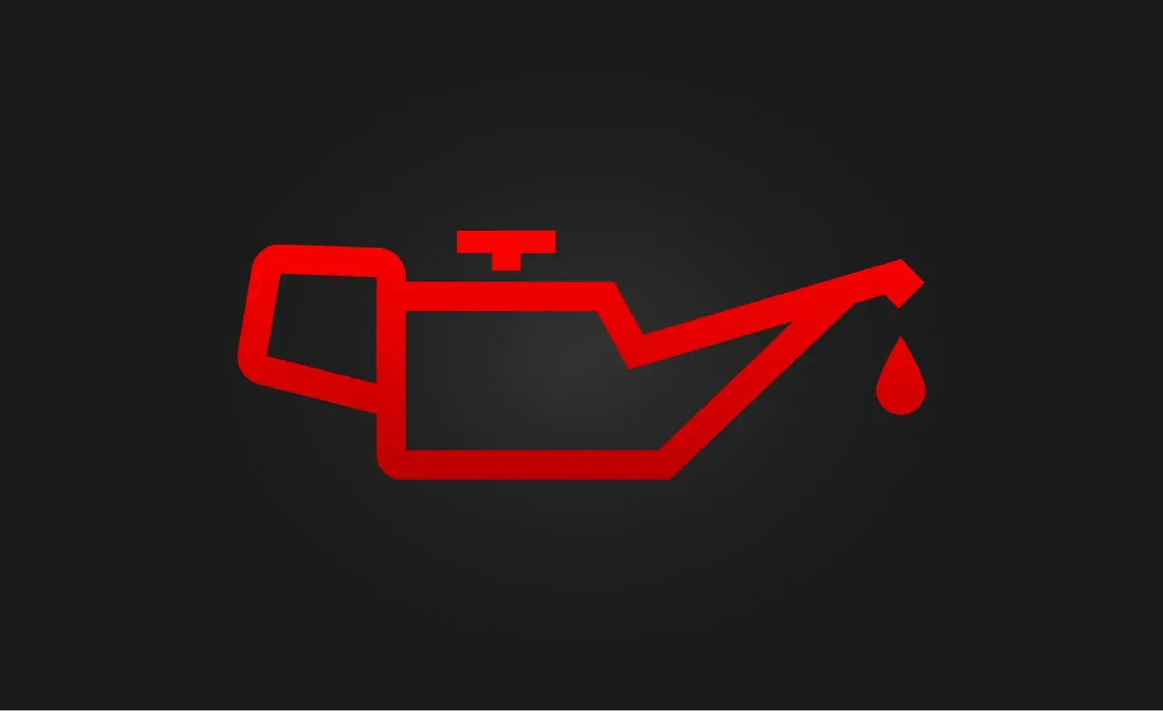 Luz de advertencia roja de un motor con exceso de aceite. Indica un problema grave que requiere atención inmediata.