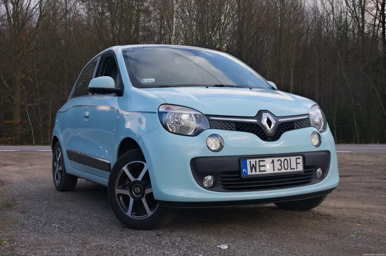 Jasnoniebieskie Renault Twingo na tle drzew. Zastanawiasz się nad jego **renault twingo spalanie**?