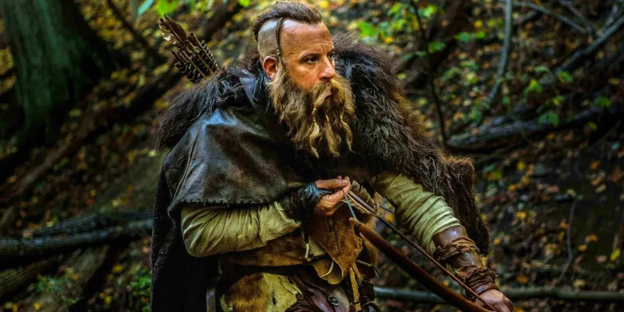En skäggig krigare med pilbåge i en skog, redo för strid som den sista häxjägaren.