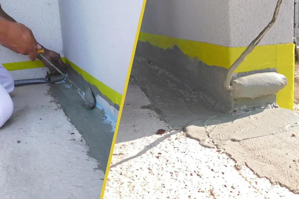 Arbeiter versiegeln Fugen der Terrasse mit einer grauen Masse. Gelbes Klebeband schützt die Wand.