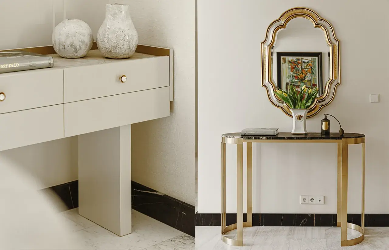 Elegancka konsola z marmurowym blatem i złotymi nogami, ozdobiona wazonem z tulipanami i flakonem perfum. Obok, biała komoda z dwoma wazonami i książką "Art Deco".