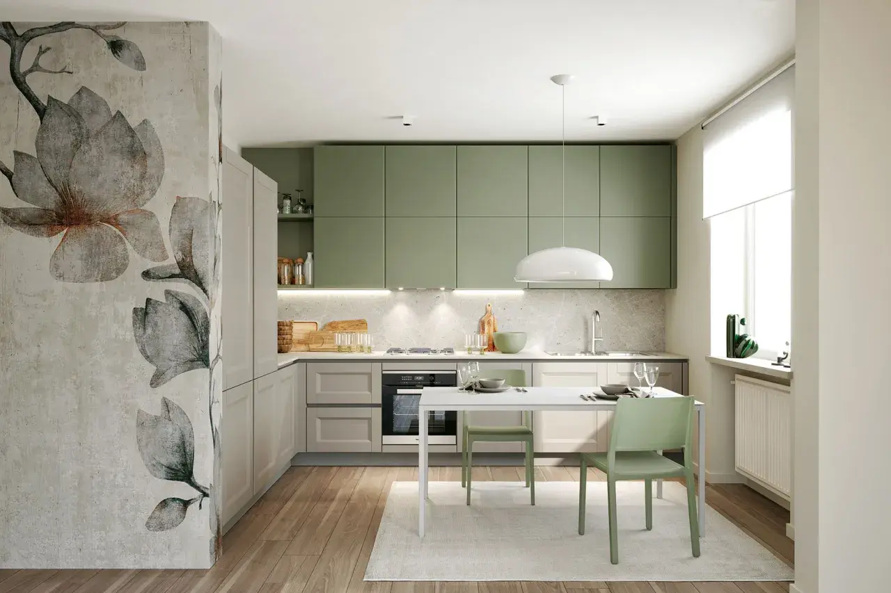 Cucina moderna con pensili color verde salvia, un murale floreale e un tavolo con sedie verdi.