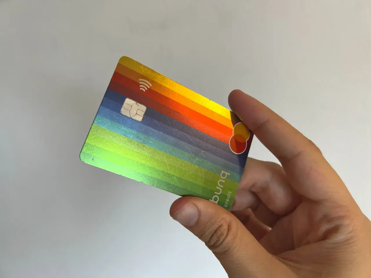 Bunte bunq Kreditkarte in der Hand. Positive bunq Erfahrungen mit diesem stylischen Design.
