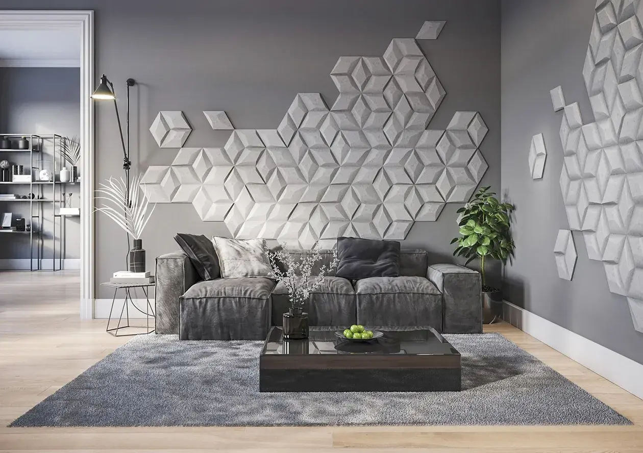 Nowoczesna dekoracja co na ścianę w pokoju: geometryczne panele 3D tworzą efektowny wzór nad szarą sofą.