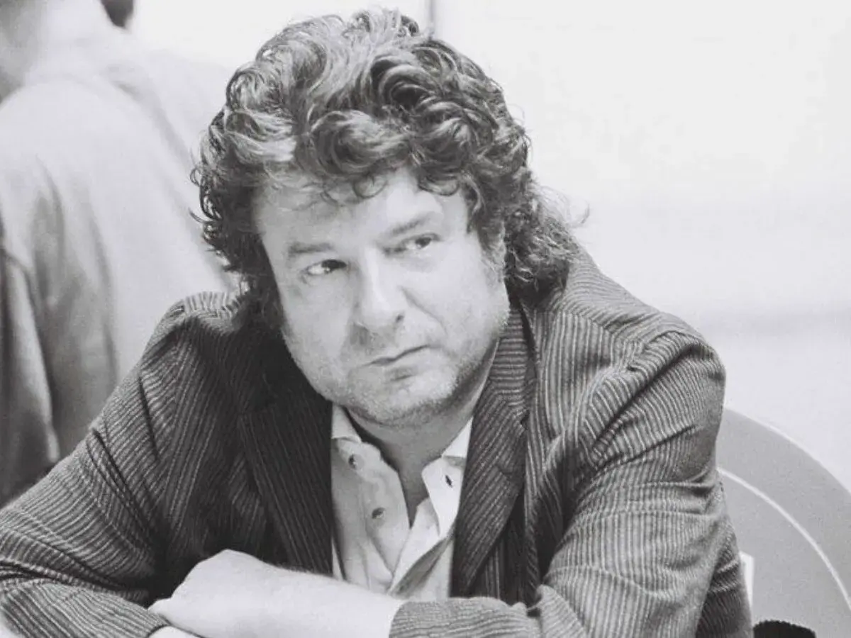 Enrique Morente joven, con su melena rizada y mirada pensativa, viste chaqueta de rayas.
