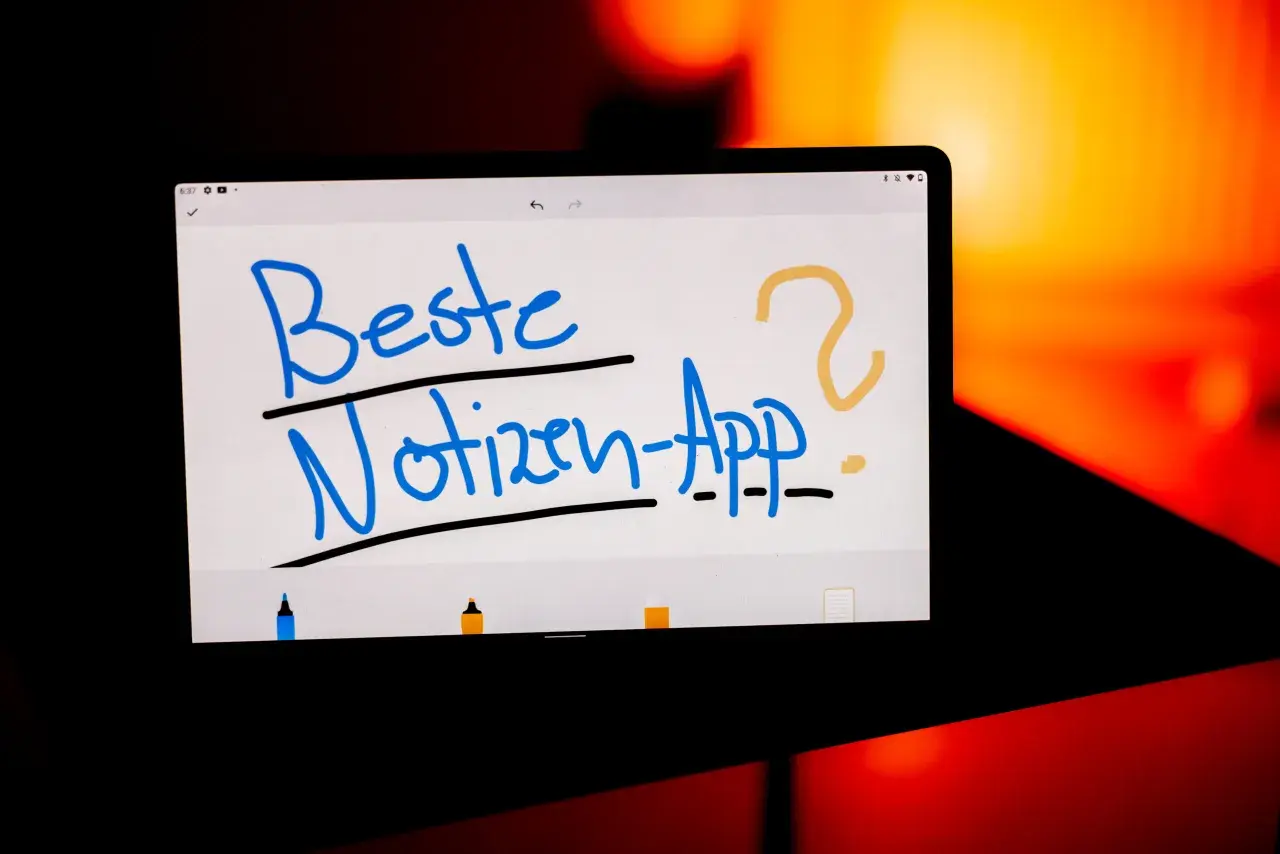 Auf einem Tablet steht in blauer Schrift "Beste Notizen-App?". Ein gelbes Fragezeichen und ein Punkt ergänzen die Frage. Ein gutes Lesezeichen für digitale Notizen.
