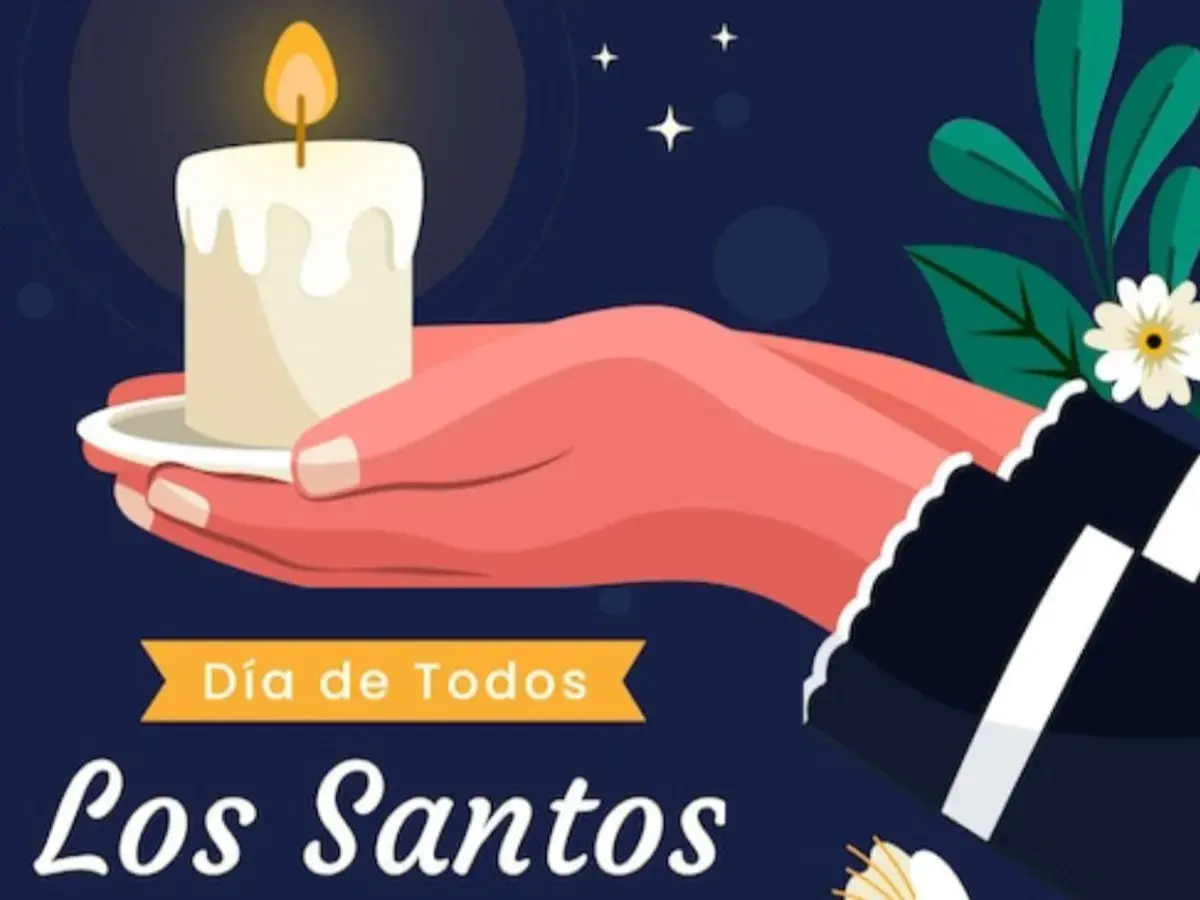 Una mano sostiene una vela encendida, símbolo de recuerdo para el Día de Todos los Santos. Frases para honrar a los que ya no están.