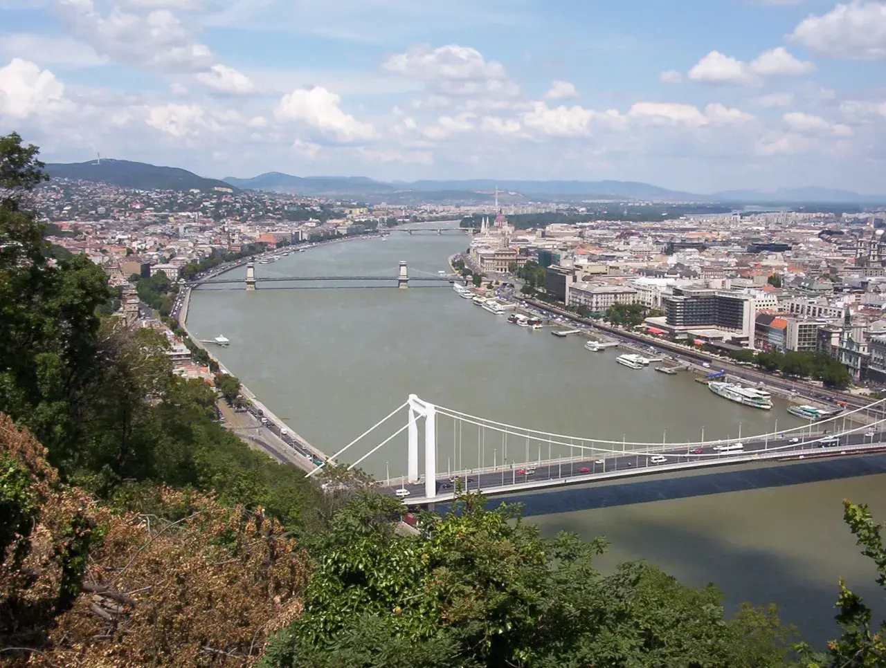 Widok na Dunaj w Budapeszcie, przypominający o tym, przez jakie państwa przepływa Dunaj, z mostami i miastem w tle.