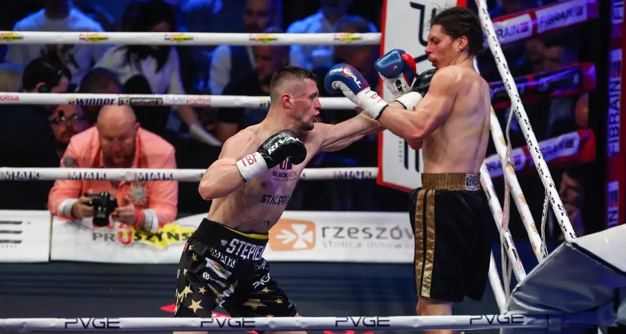 Dwóch bokserów walczy na ringu podczas babilon boxing show. Jeden z nich wyprowadza cios.