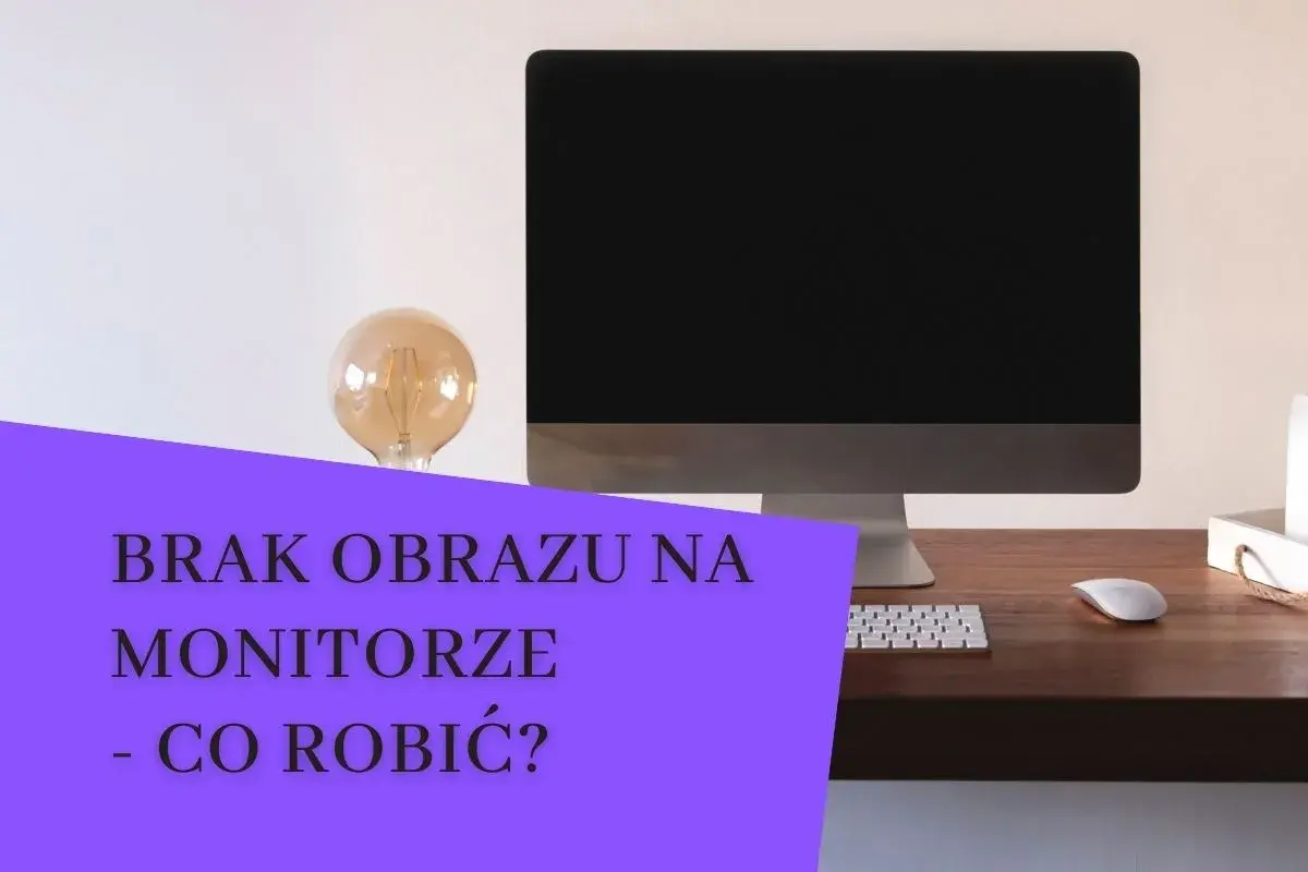 Komputer z czarny ekranem na biurku. Obok żarówka i klawiatura. Brak obrazu na monitorze - co robić?
