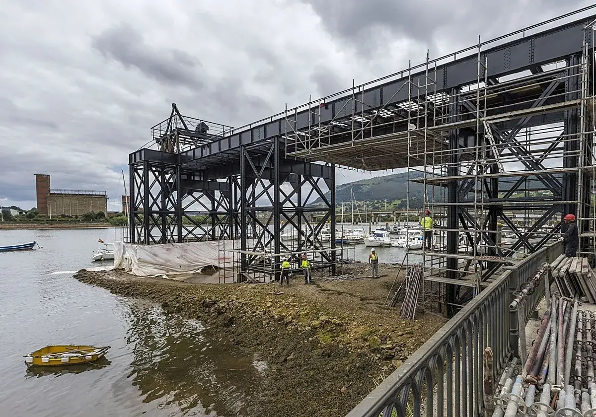 Obras en el puente de Santander, con andamios y trabajadores junto a la ría. Yates amarrados al fondo.