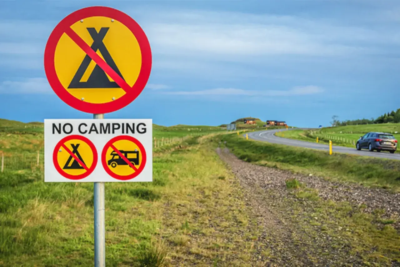 Schilder verbieten das Zelten und Wohnmobilfahren. Kein **island wildcampen** hier, nur eine Straße mit einem Auto.