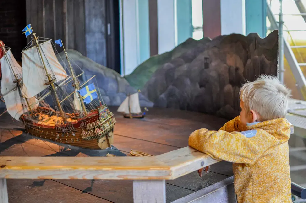Barn fascineras av en modell av regalskeppet Vasa på Vasamuseet.