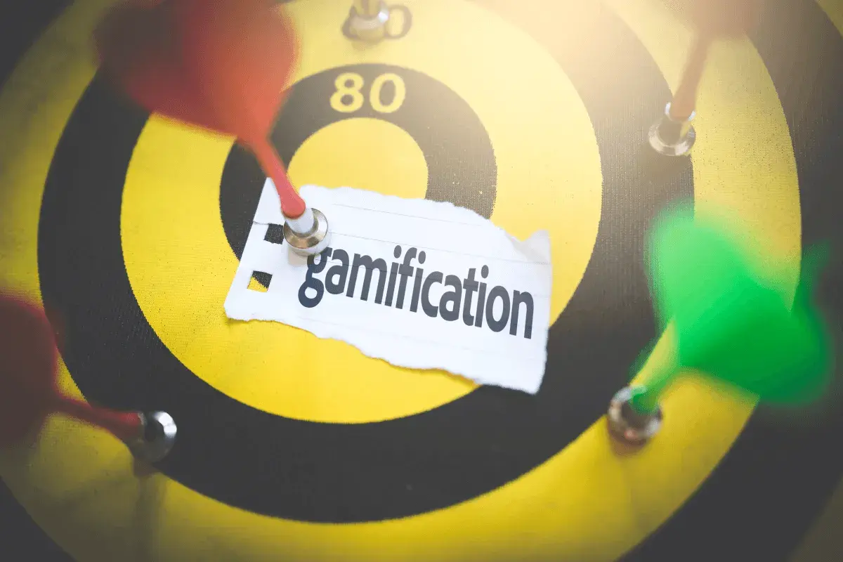 Rzutki na tarczy symbolizują cel, a napis "gamification" wskazuje na strategię grywalizacji w biznesie.