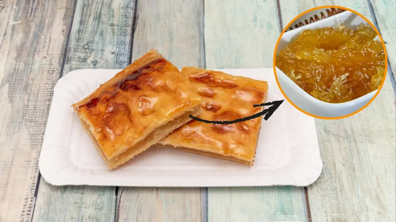 Dos trozos de pastel dorado con un relleno que parece pelo de ángel, servidos en un plato de papel.