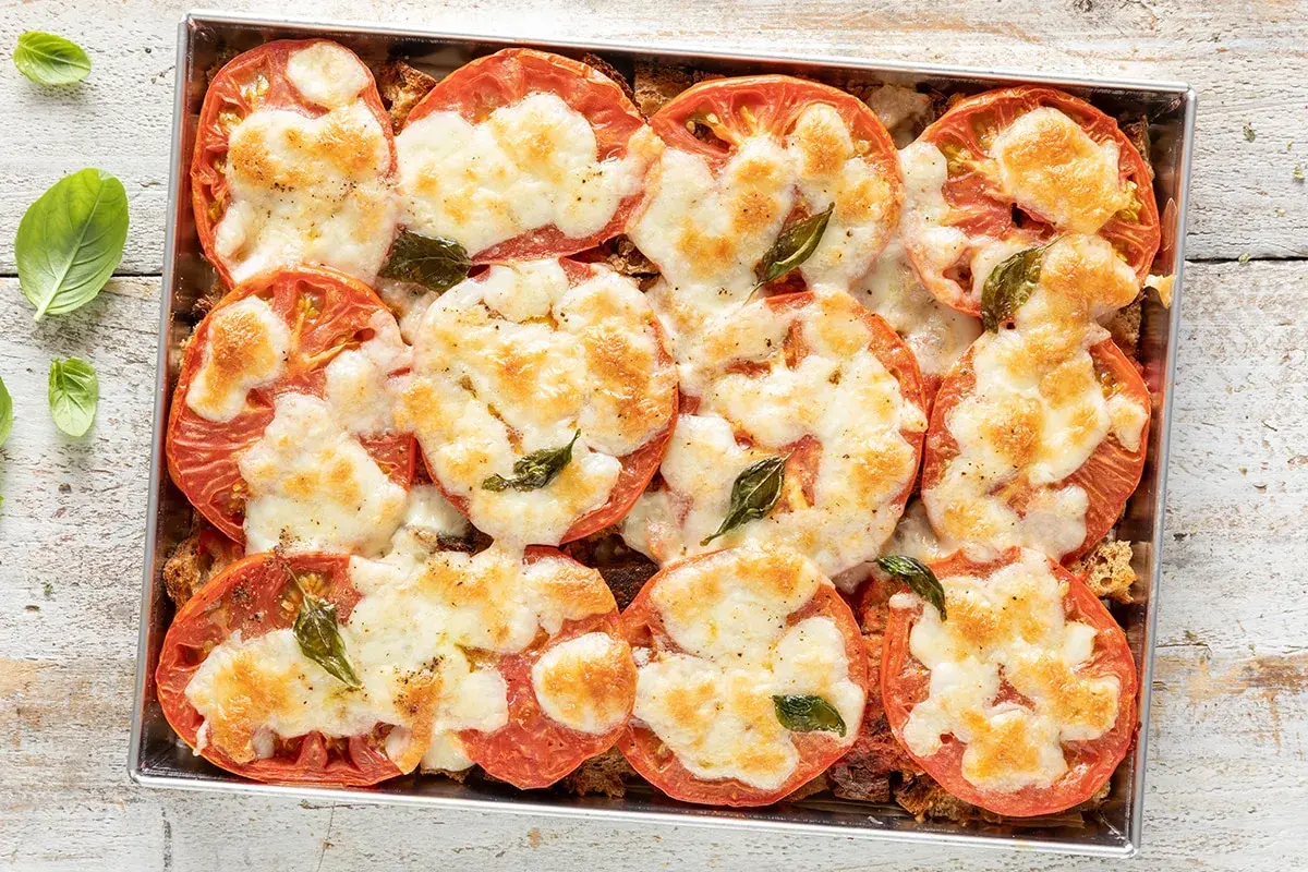 Pomodori al forno con mozzarella filante e basilico. Un'idea gustosa per cosa mangiare stasera, semplice e veloce da preparare.