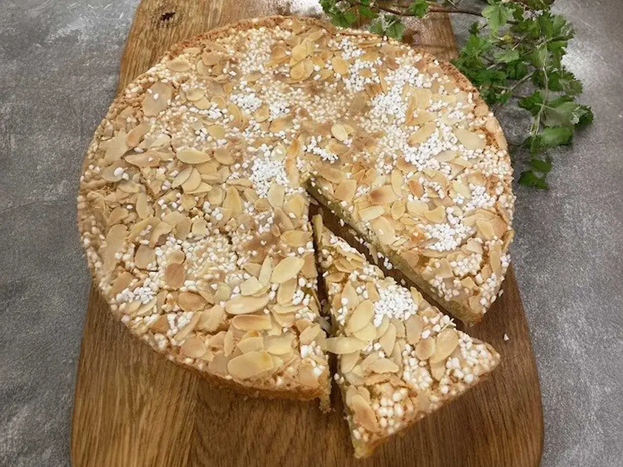 En saftig italiensk mandelkaka med citron, toppad med mandelflagor och pärlsocker. Perfekt för fikat!