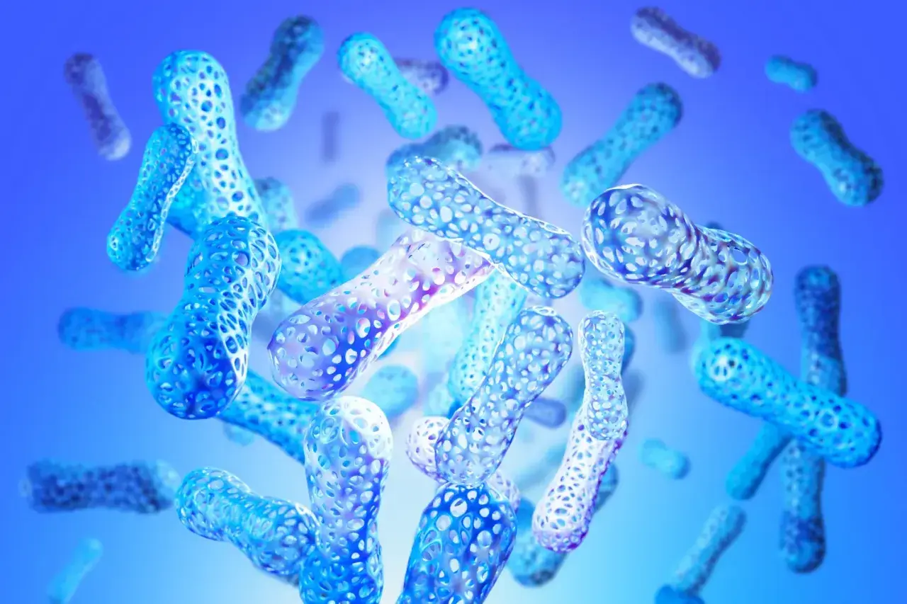 Forme blu traslucide, simili a bastoncini, con texture a nido d'ape, fluttuano in uno spazio blu. Rappresentano enzimi digestivi naturali.