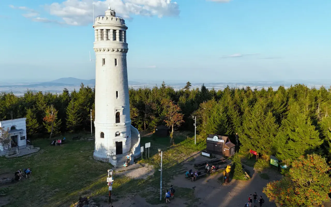 Wieża widokowa na szczycie góry, otoczona lasem. To popularne miejsce na wielka sowa trasa, gdzie turyści odpoczywają i podziwiają panoramę.