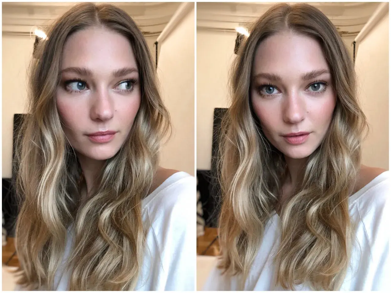 En kvinna med blont, vågigt hår och en subtil, naturlig makeup som framhäver hennes blå ögon och rosiga kinder.
