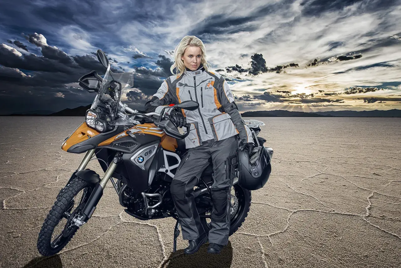 Donna in abbigliamento tecnico da moto, pronta per un'avventura. Ecco come vestirsi per andare in moto donna, con giacca e pantaloni protettivi.