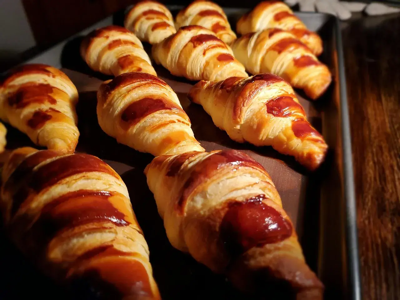 Une fournée de croissants dorés, parfaits pour une recette facile. Ils sont brillants et appétissants.