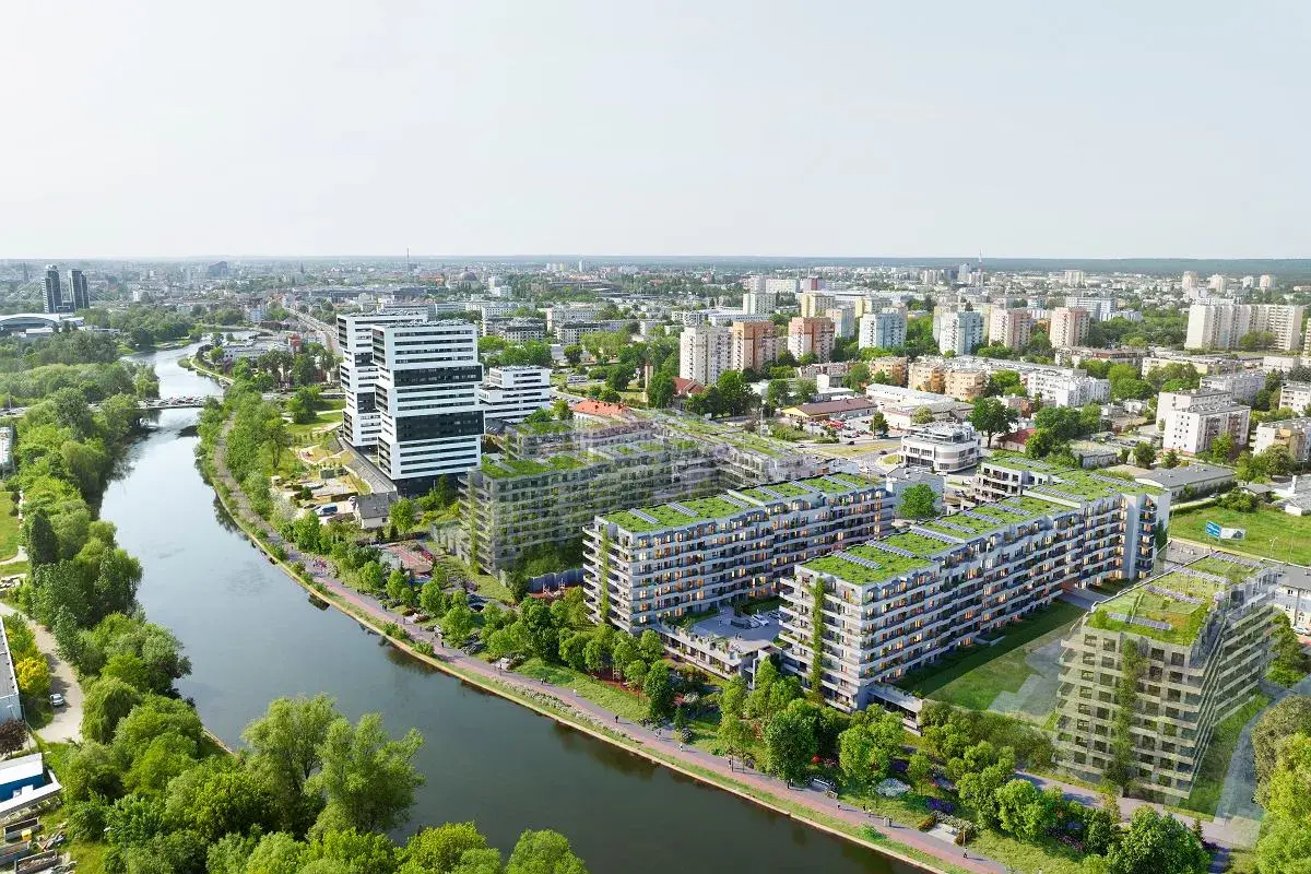 Nowoczesne osiedle apartamentowe z zielonymi dachami nad rzeką w Bydgoszczy.
